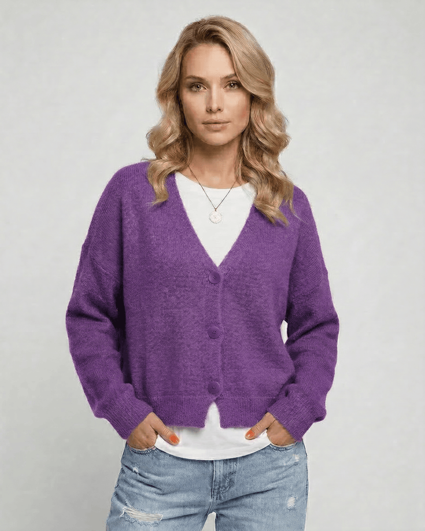 Iris Cardigan by Lauven in vibrant purple worn by model, showcasing cozy knitwear and relaxed V-neck design.