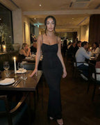 Isla Maxi Dress by Lauven - Black sleeveless spaghetti strap sheath dress, elegant fit in a restaurant setting.