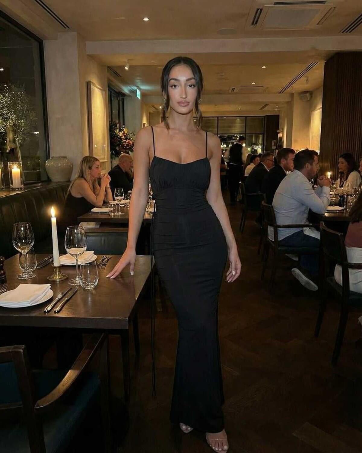 Isla Maxi Dress by Lauven - Black sleeveless spaghetti strap sheath dress, elegant fit in a restaurant setting.
