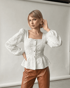 Ivory Corset Top by Lauven featuring a jacquard square neck and puff sleeves, styled with leather pants.