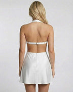 Back view of Ivory Mini Dress by Lauven with halter neck and cut-out design, showcasing sleek satin fabric.
