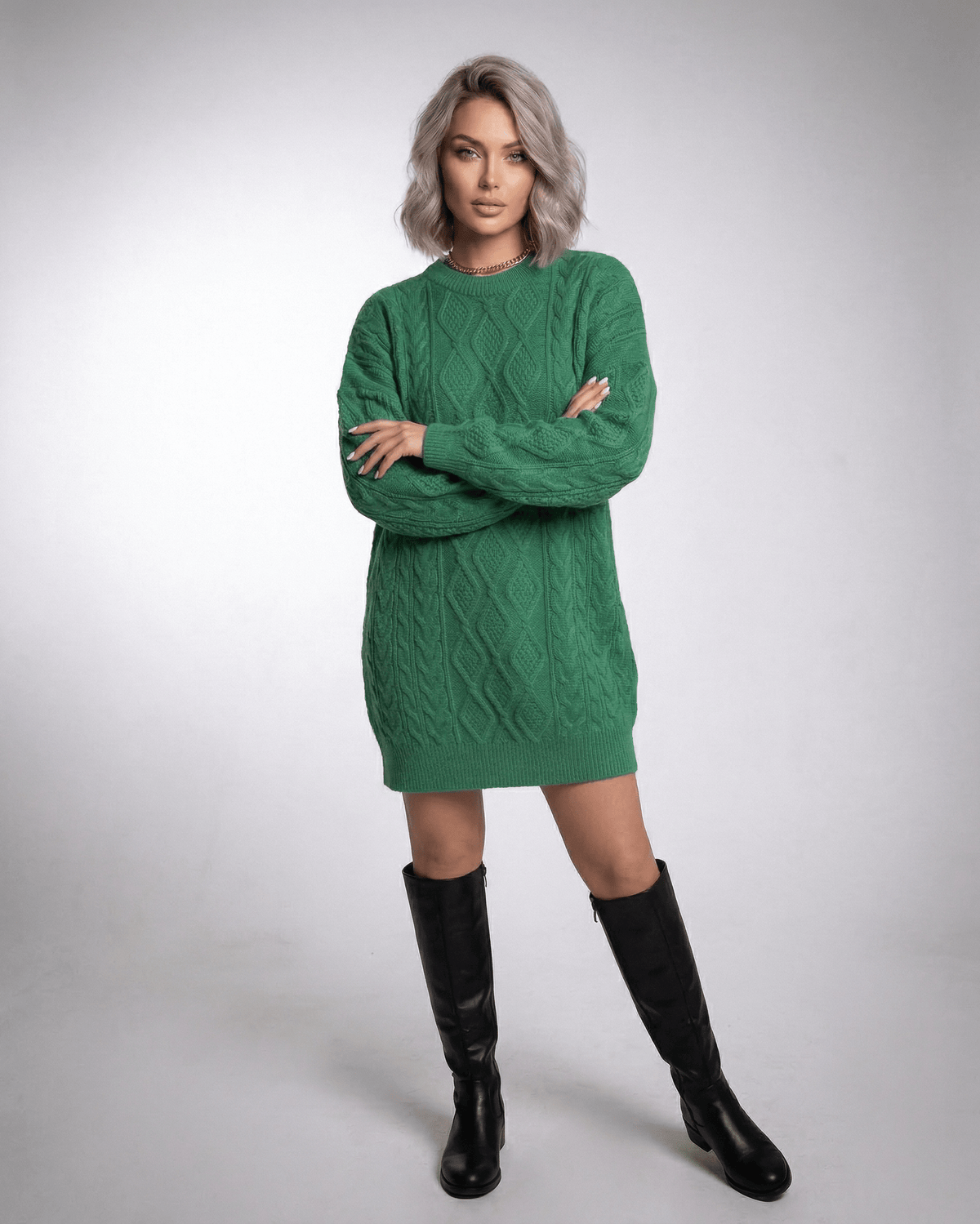 Model wearing Ivy Mini Dress in Emerald Green Cable Knit by Lauven, showcasing a loose fit and ribbed trims.