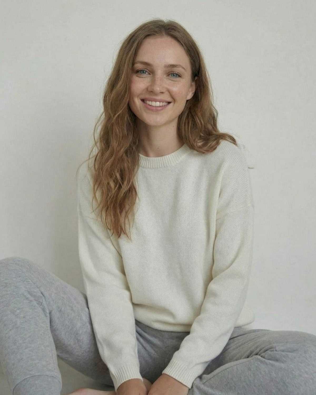 Alba Pullover by Lauven - Relaxed wool knit sweater on a smiling woman, showcasing a soft and modern look.