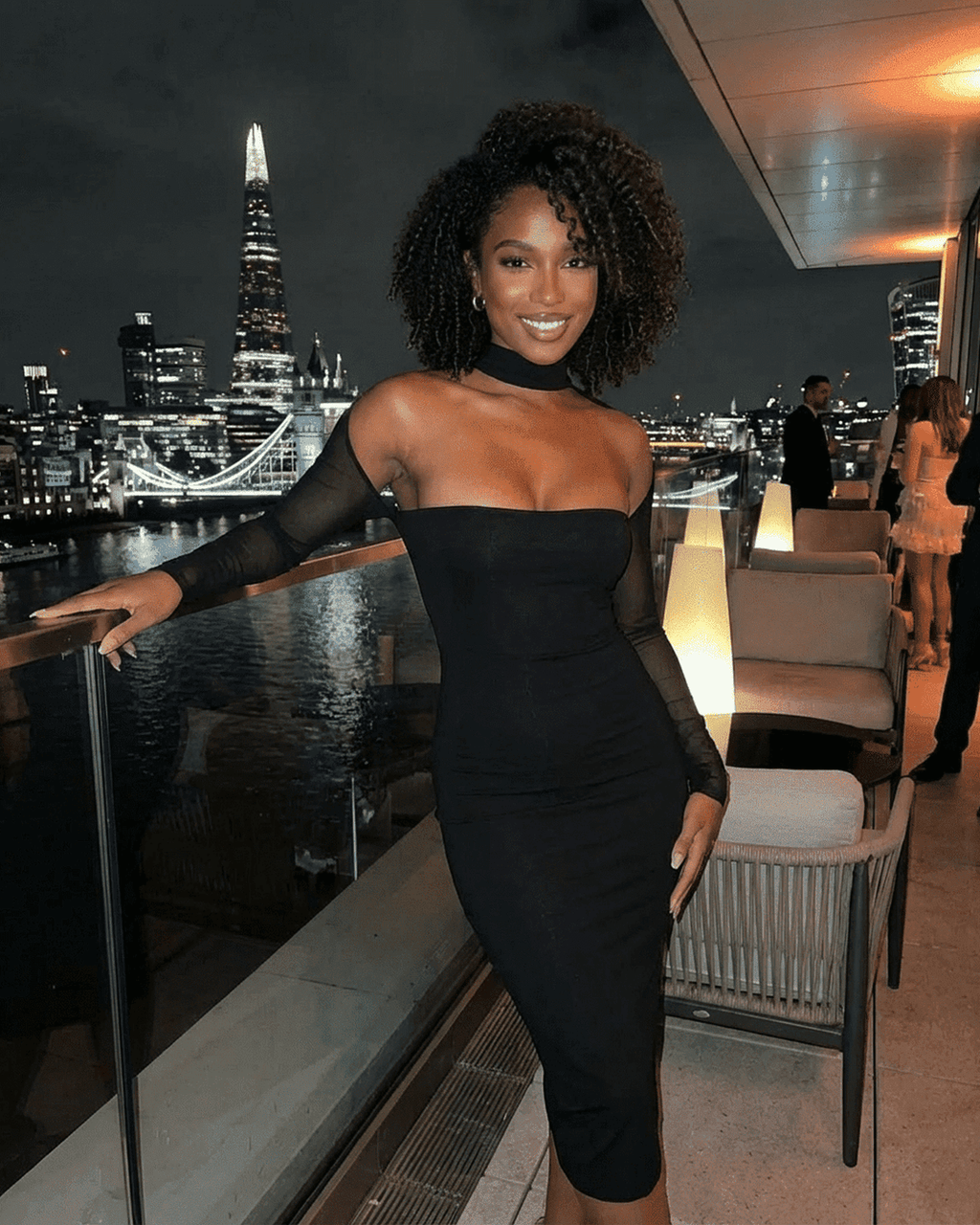 Arden Midi Dress by Lauven showcased in a chic evening setting with city skyline background.