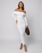 Model showcasing the Auriel Midi Dress by Lauven, an off-the-shoulder, ruched white midi dress.