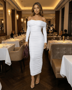 Auriel Midi Dress by Lauven worn in an upscale restaurant, showcasing off-the-shoulder style and ruched elegance.