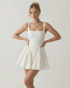 Aurora Mini Dress by Lauven, square neck backless white mini dress with bow detail, modern minimalist design.