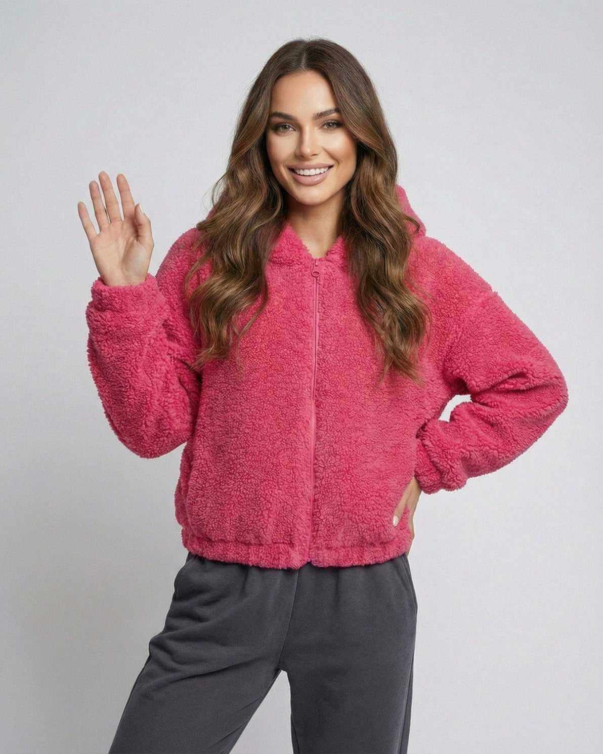 Model wearing the Berry Fleece Jacket by Lauven, showcasing its cozy teddy texture and vibrant pink color.