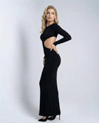 Model wearing the Monaco Maxi Dress by Lauven, a sleek black long sleeve cut out maxi dress.