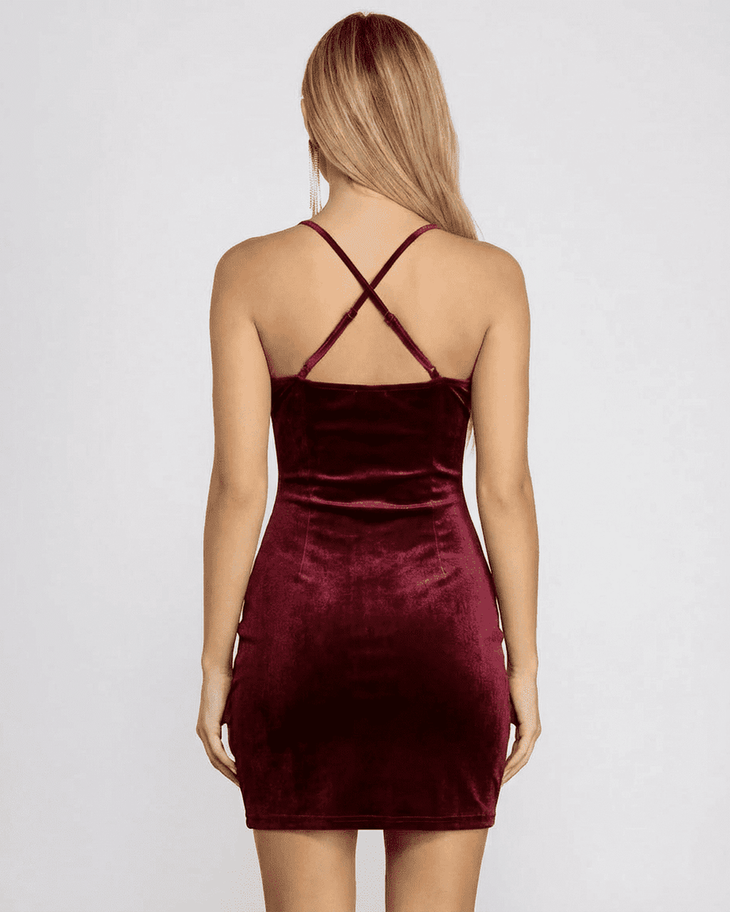 Back view of the elegant Bordeaux Mini Dress by Lauven, showcasing its velvet fabric and crisscross straps.