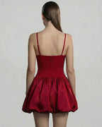 Back view of the Carmine Mini Dress by Lauven, featuring a sculpted bodice and a voluminous puff skirt.