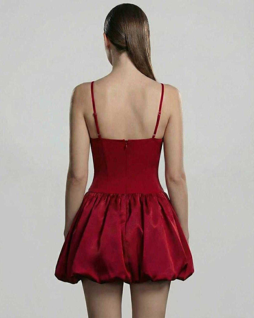 Back view of the Carmine Mini Dress by Lauven, featuring a sculpted bodice and a voluminous puff skirt.