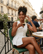 Model wearing Celeste Blouse by Lauven, enjoying coffee at a Parisian café.