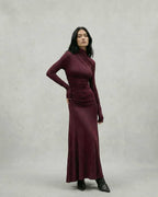 Elegant model wearing the Celeste Maxi Dress in burgundy, showcasing a sheath silhouette by Lauven.