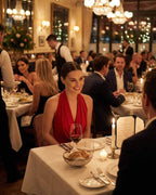 Celeste Maxi Dress by Lauven worn by a woman at an elegant dinner, showcasing the luxurious red satin silhouette.