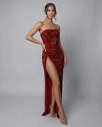 Celeste Maxi Dress by Lauven, an elegant red sequin strapless gown with a daring high slit, perfect for evening occasions.