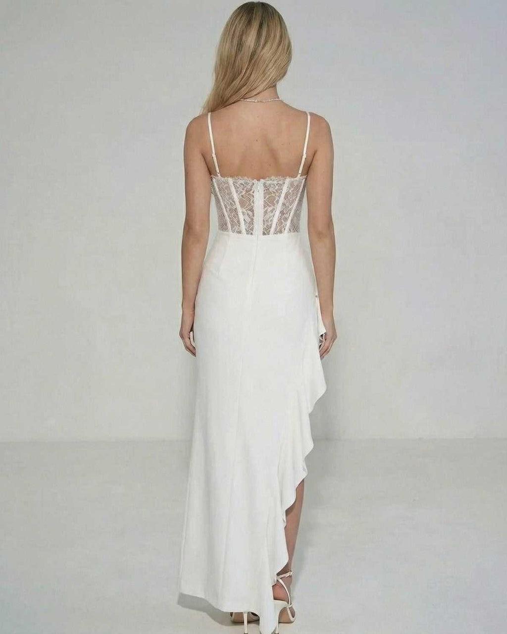 Back view of Celeste Maxi Dress by Lauven showcasing sheer lace bodice and ruffled skirt detail.