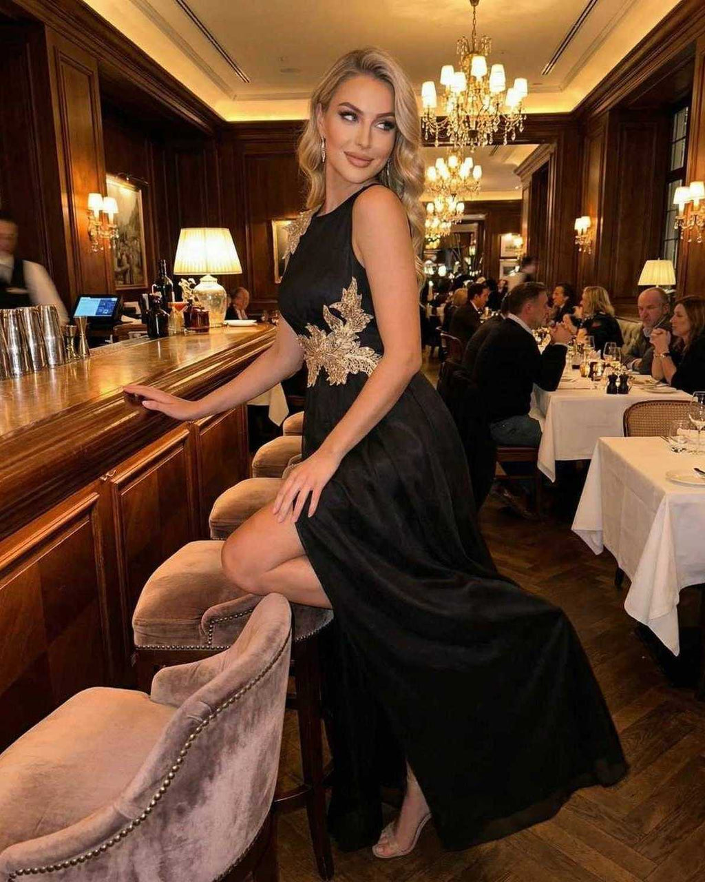 Celeste Maxi Dress by Lauven, elegant sleeveless black dress with patchwork detail at a stylish restaurant.