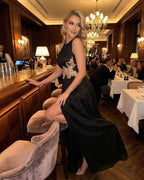 Celeste Maxi Dress by Lauven, elegant sleeveless black dress with patchwork detail at a stylish restaurant.