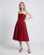 Celeste Midi Dress by Lauven, strapless high-waist silhouette in elegant red with pockets, perfect for modern occasions.