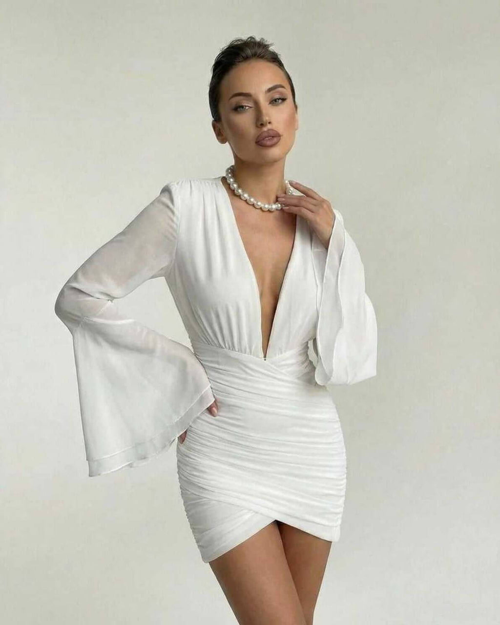 Celeste Mini Dress by Lauven featuring a V-neck, ruched sheath silhouette, and sheer dramatic sleeves.
