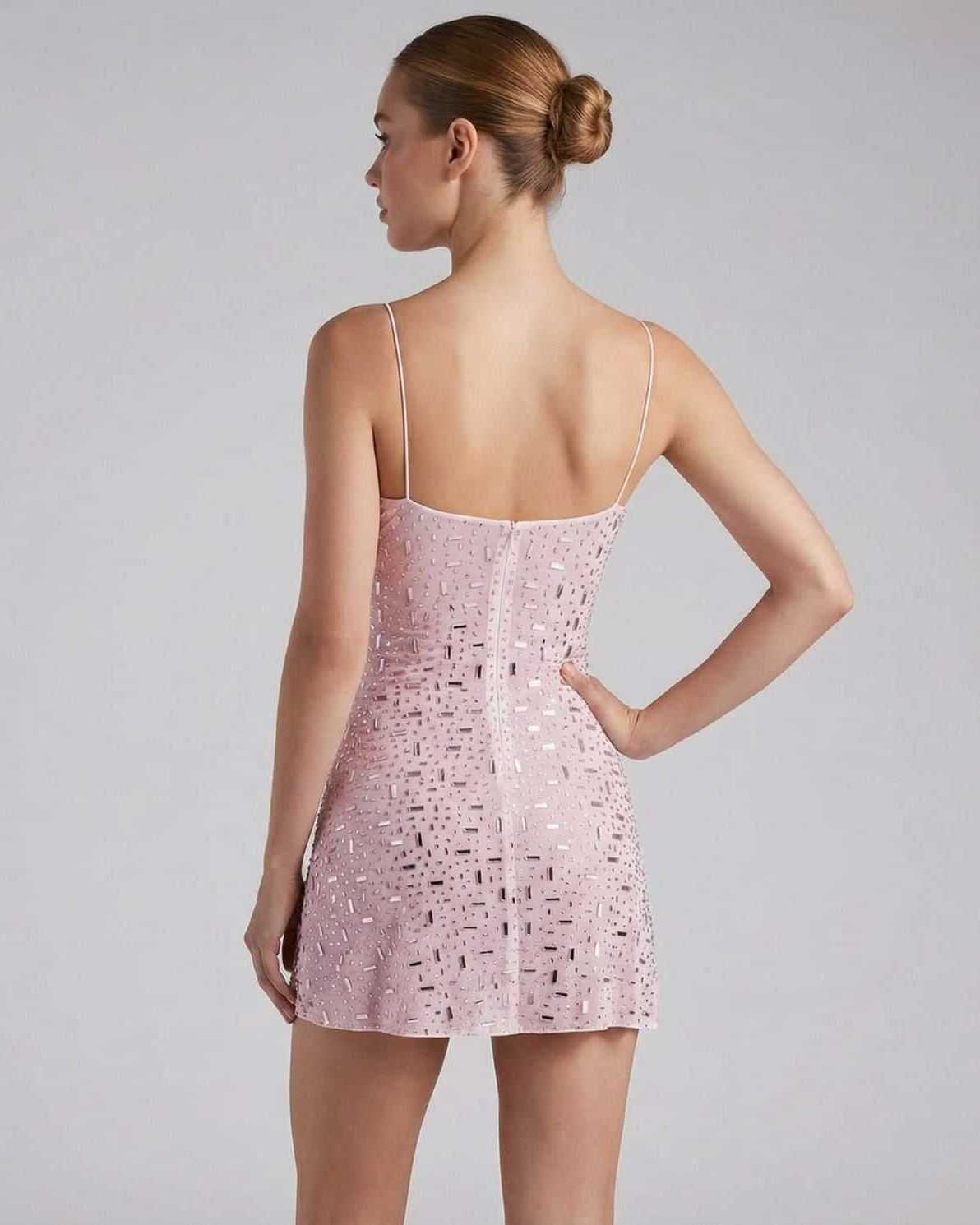 Celeste Mini Dress by Lauven, featuring a pink fabric with rhinestone embellishments and spaghetti straps from the back.