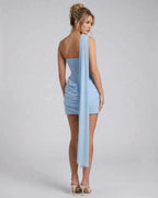 Celeste Mini Dress by Lauven featuring a stylish one-shoulder design and soft ruffle detailing in light blue.
