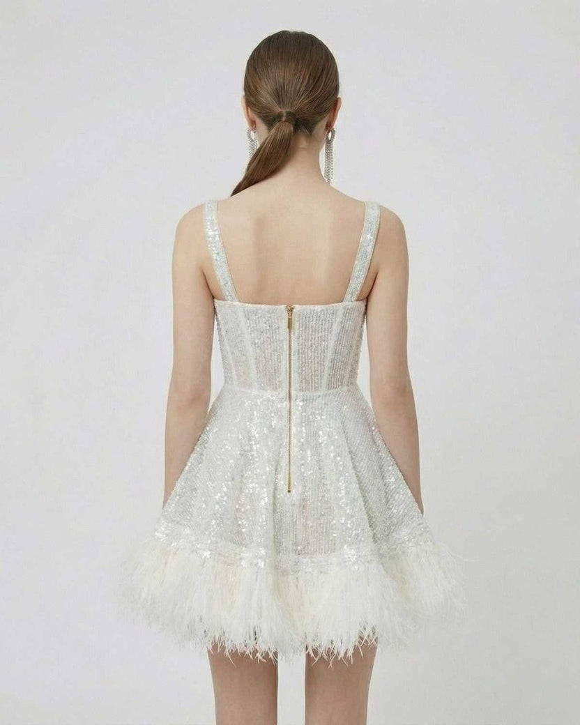 Celeste Mini Dress by Lauven - Back view of silver sequin A-line mini dress with faux fur hem