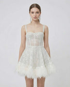 Celeste Mini Dress by Lauven, silver sequin A-line mini dress with faux fur hem and spaghetti straps.