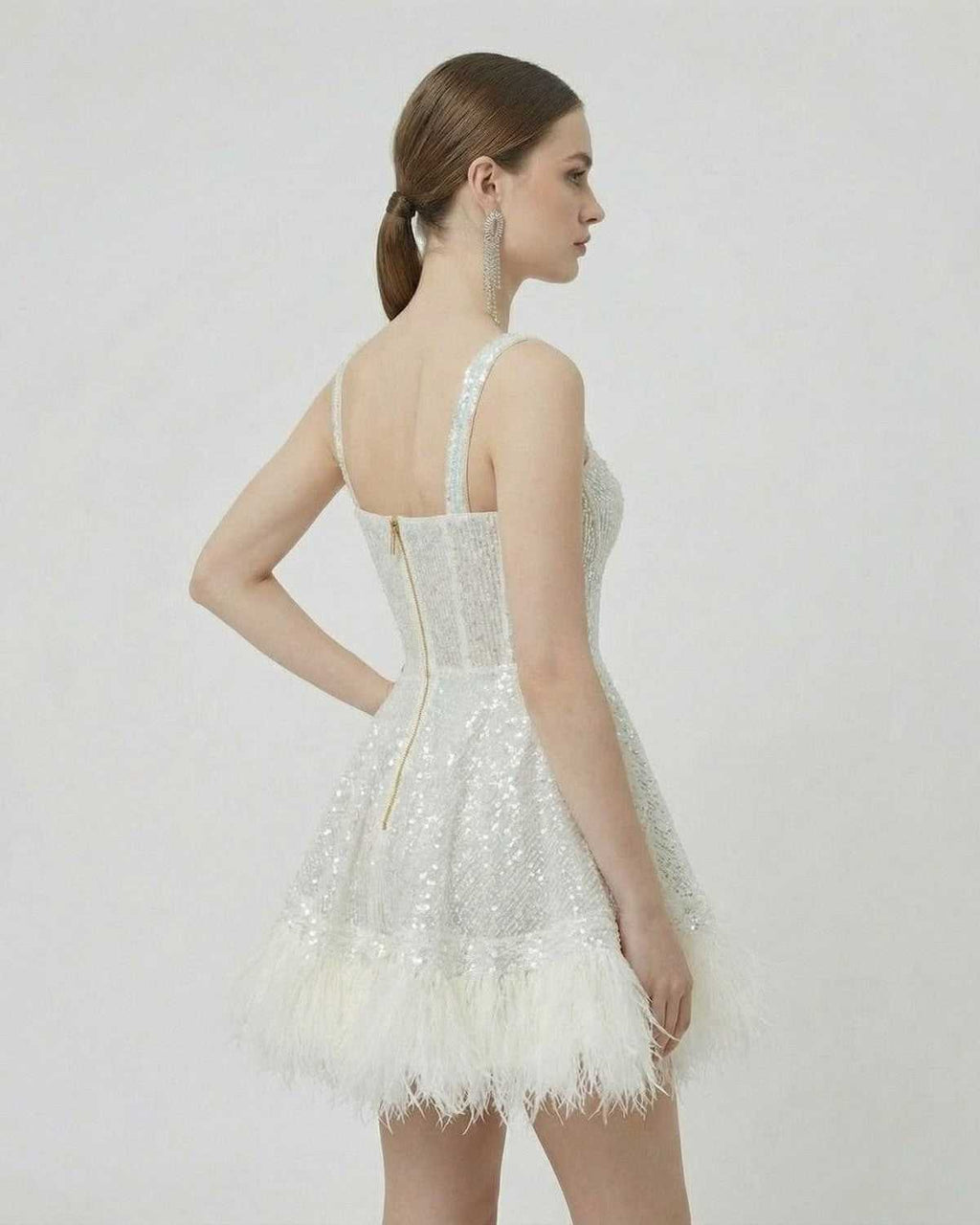 Celeste Mini Dress by Lauven, silver sequin A-line mini dress with faux fur hem, showcasing a refined silhouette.