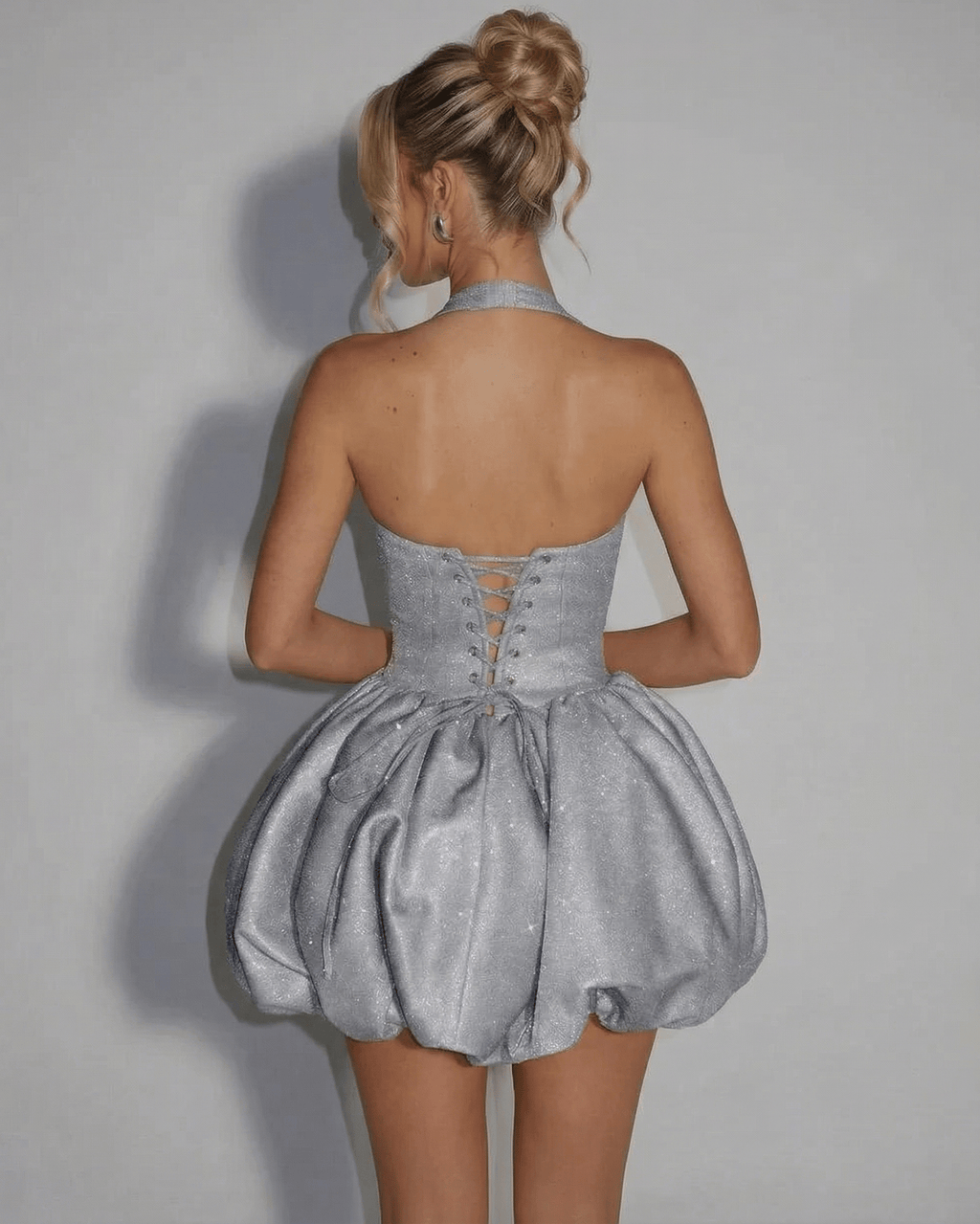 Celeste Mini Dress by Lauven, silver sequin pouf silhouette showcasing a stylish back design. Perfect for any special occasion.
