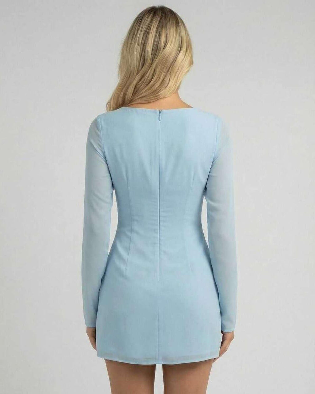 Celeste Mini Dress by Lauven in soft blue, showcasing a sleek silhouette and elegant long sleeves from the back.