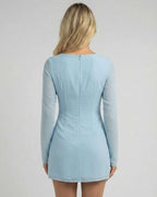 Celeste Mini Dress by Lauven in soft blue, showcasing a sleek silhouette and elegant long sleeves from the back.