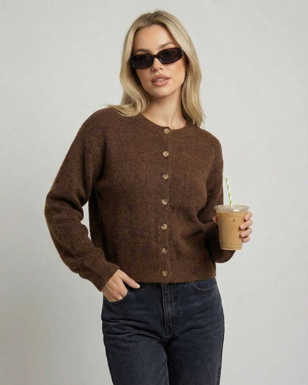 Cocoa Cardigan by Lauven on model in sunglasses, holding a drink, showcasing a relaxed fit and button-front design.