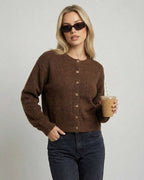 Cocoa Cardigan by Lauven on model in sunglasses, holding a drink, showcasing a relaxed fit and button-front design.