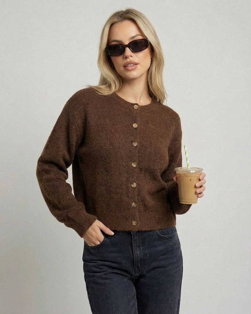 Cocoa Cardigan by Lauven on model in sunglasses, holding a drink, showcasing a relaxed fit and button-front design.