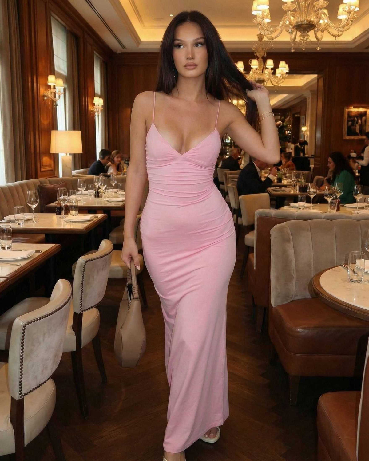 Elara Maxi Dress by Lauven, a sleek sleeveless dress in soft blush pink, showcasing a refined silhouette in a stylish restaurant setting.