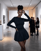 Elara Mini Dress by Lauven showcased in a fashion event, featuring a fitted stretchy silhouette and elegant tiered skirt.