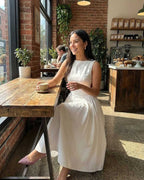 Elysia Midi Dress by Lauven, elegant A-line sleeveless dress captured in a cozy café setting.