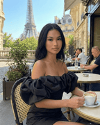 Elysia Mini Dress by Lauven worn in Paris, featuring ruffle trim and off-the-shoulder style with the Eiffel Tower backdrop.