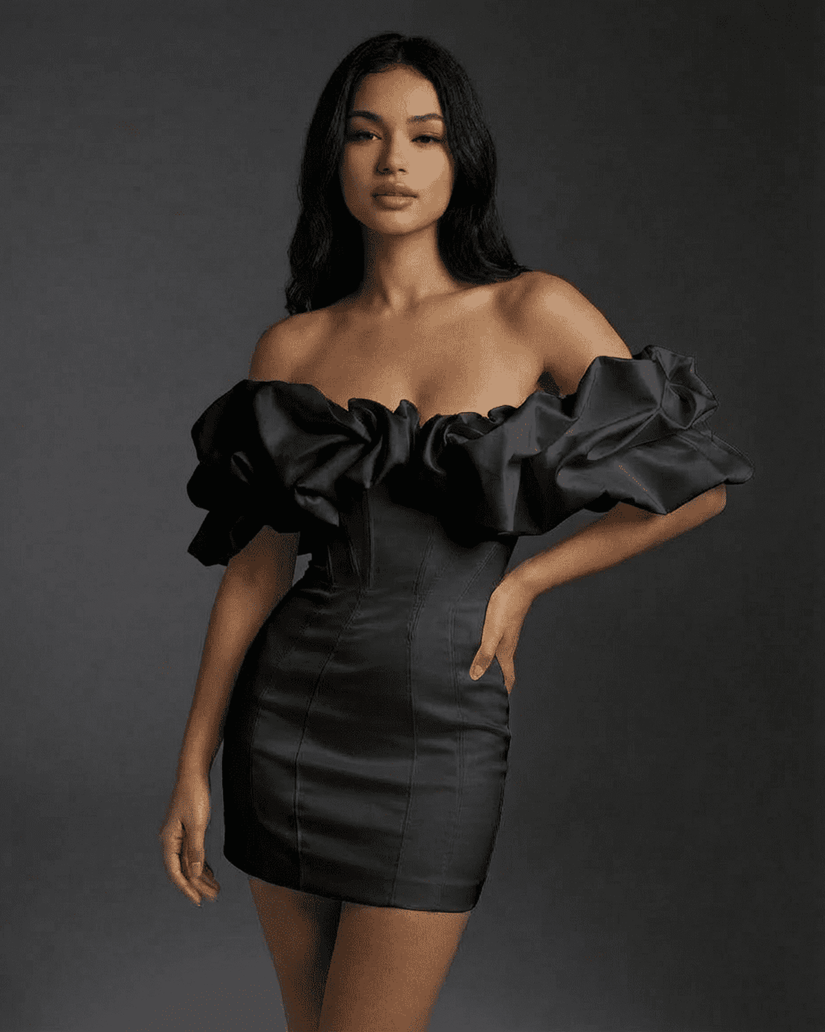 Elysia Mini Dress by Lauven featuring a boned structure and ruffle trim in black fabric, modeled elegantly.