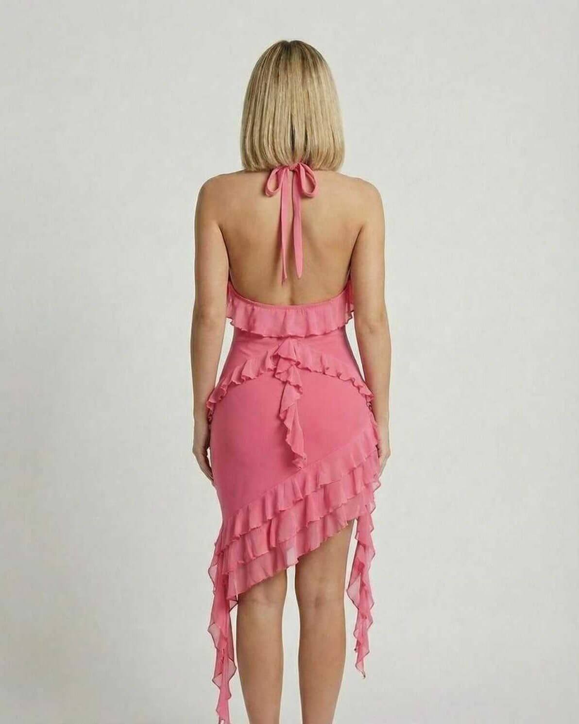 Flora Mini Dress by Lauven in soft pink with ruffle detail, showcasing a chic halter-neck design from the back.