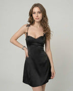 Florence Mini Dress by Lauven - Satin slip dress with ruffle trim and spaghetti straps, showcasing a sleek silhouette.