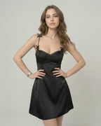 Model wearing Florence Mini Dress by Lauven, featuring a satin slip silhouette, ruffle trim, and delicate straps.