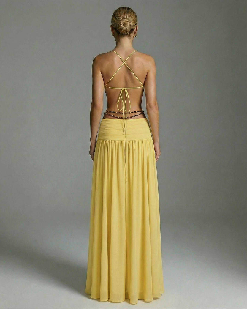 Back view of the Heliora Maxi Dress by Lauven, showcasing its yellow hue and elegant floor-length design.