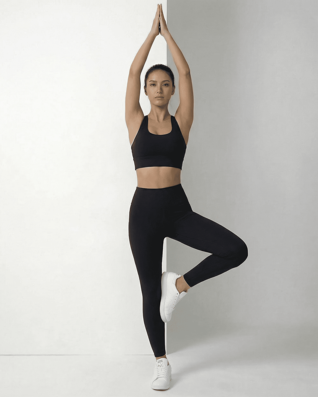 Iris Leggings Black on model in black sports bra, showcasing sleek design and comfortable fit by Lauven.