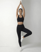 Iris Leggings Black on model in black sports bra, showcasing sleek design and comfortable fit by Lauven.