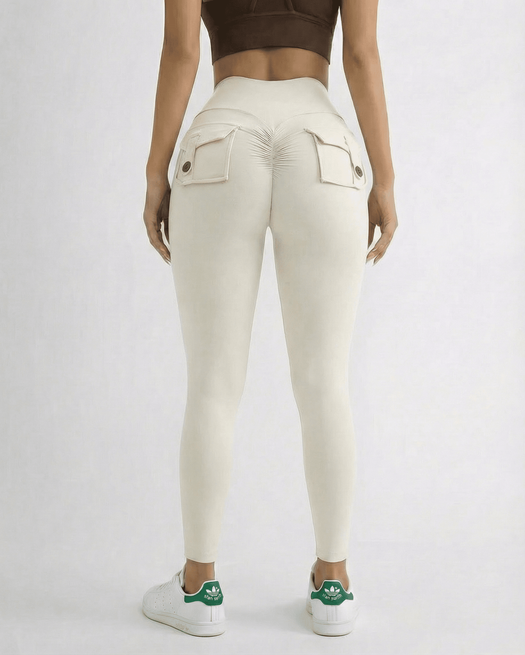 Back view of a model wearing Iris Leggings Cream by Lauven, featuring pockets and a high waistband.