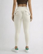 Back view of a model wearing Iris Leggings Cream by Lauven, featuring pockets and a high waistband.