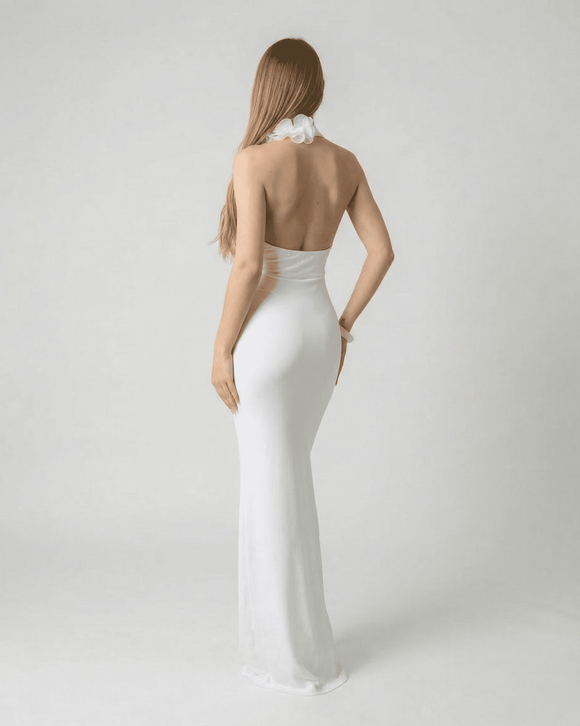 Lumière Maxi Dress by Lauven - Back view of a white deep V neck backless maxi dress with 3D floral detail.